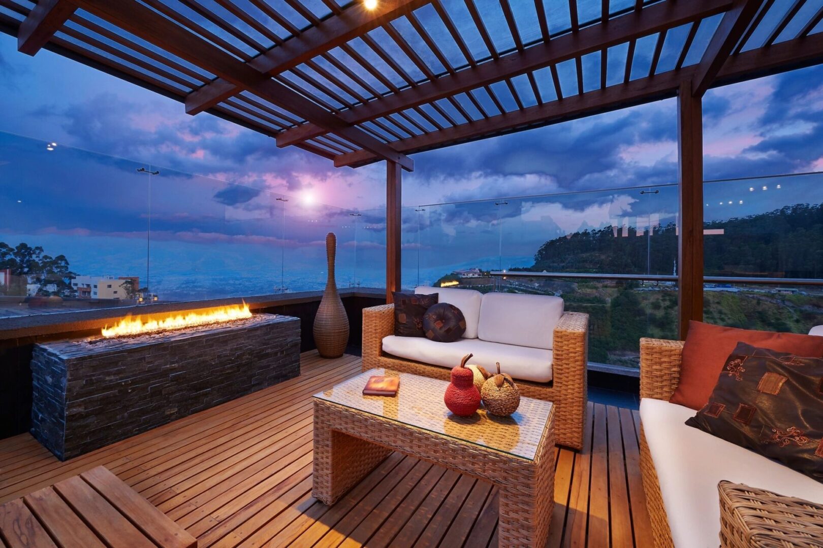 Rooftop patio with fire pit and city view.